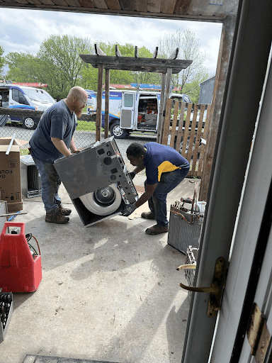 Team from Advantage Latta-Whitlow wheeling in a Furnace for HVAC installation in De Soto.