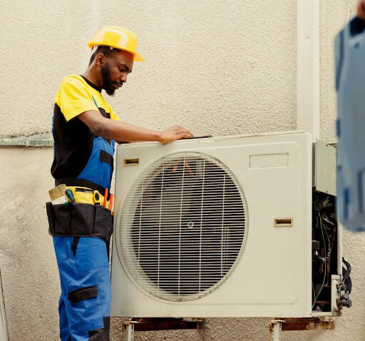 Advantage Latta-Whitlow technician repairing heat pump in Eudora